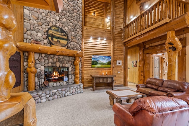 3700 Glen Lake Rd, Eureka, MT 59917 - carpeted living room featuring a towering ceiling, a stone fireplace, and wooden walls