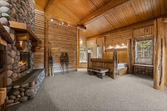 3700 Glen Lake Rd, Eureka, MT 59917 - unfurnished bedroom with a wood ceiling with exposed beams, carpet, a fireplace, and wooden walls