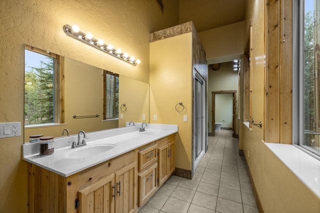 3700 Glen Lake Rd, Eureka, MT 59917 - bathroom featuring a textured wall, double vanity, tile patterned floors, and a bathtub