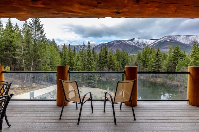 3700 Glen Lake Rd, Eureka, MT 59917 - deck featuring a wooded view and a mountain view