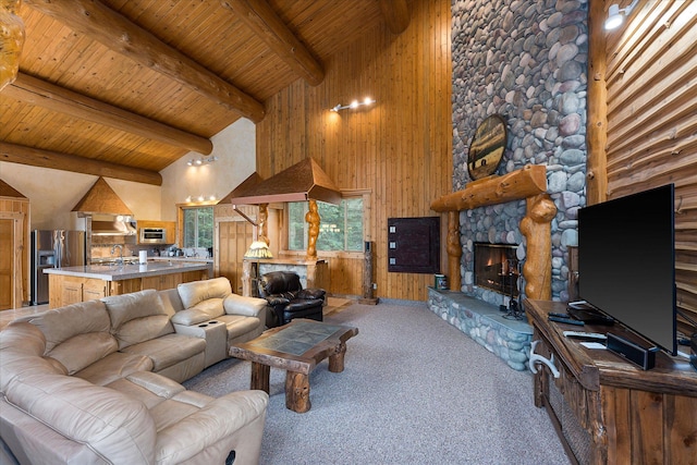 3700 Glen Lake Rd, Eureka, MT 59917 - living area with a fireplace, a wood ceiling with exposed beams, high vaulted ceiling, wood walls, and light carpet