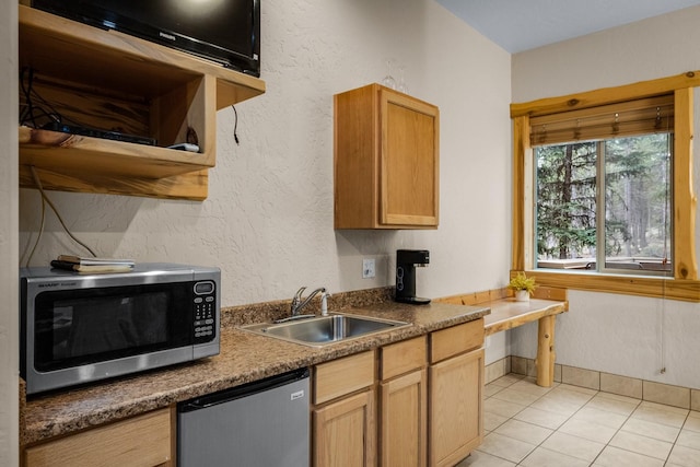 3700 Glen Lake Rd, Eureka, MT 59917 - kitchen featuring stainless steel microwave, dishwasher, light tile patterned floors, and a textured wall