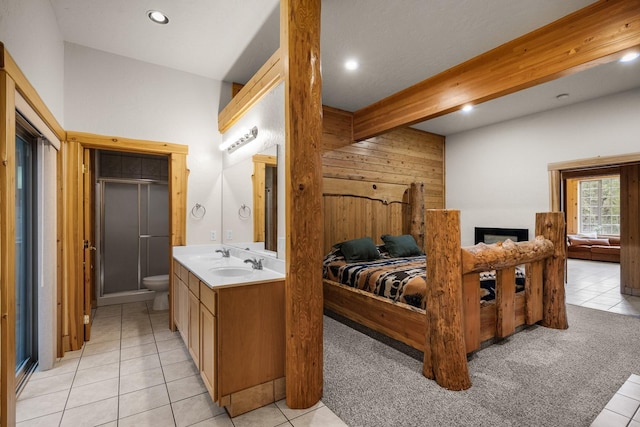 3700 Glen Lake Rd, Eureka, MT 59917 - bedroom with light tile patterned floors, recessed lighting, wood walls, light carpet, and beamed ceiling