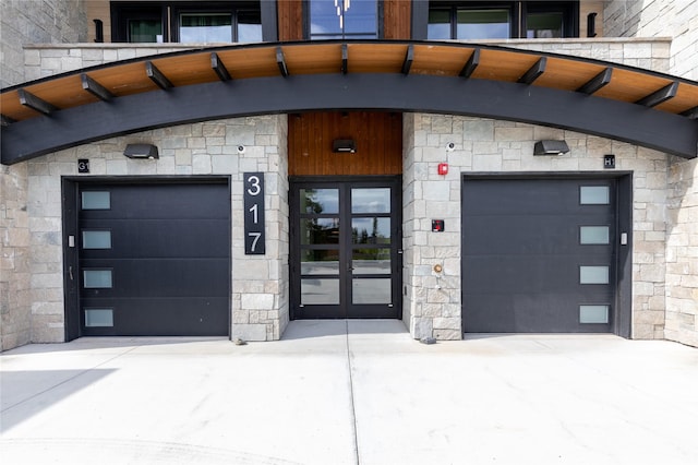 317 Akers Ln Unit H, Whitefish, MT 59937 - view of exterior entry featuring french doors, stone siding, and driveway