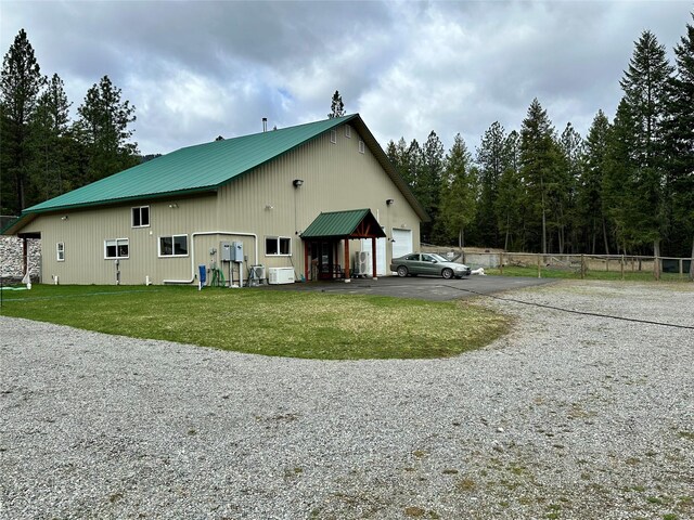 85 Osprey Dr E, Thompson Falls, MT 59873 - view of side of home with asphalt driveway, a yard, and a detached garage