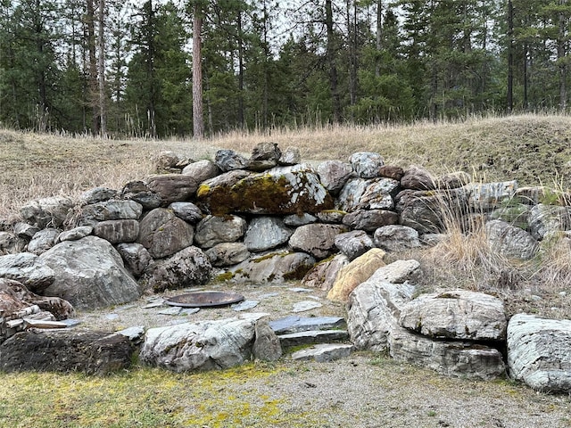 85 Osprey Dr E, Thompson Falls, MT 59873 - view of yard featuring an outdoor fire pit and a wooded view