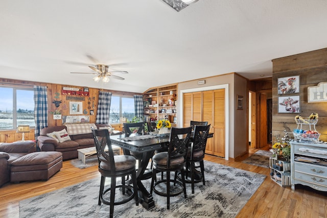 44688 N Foothills Dr, Ronan, MT 59864 - dining room with wooden walls, a ceiling fan, and light wood finished floors