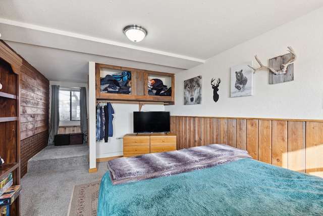 44688 N Foothills Dr, Ronan, MT 59864 - carpeted bedroom with wood walls and a wainscoted wall