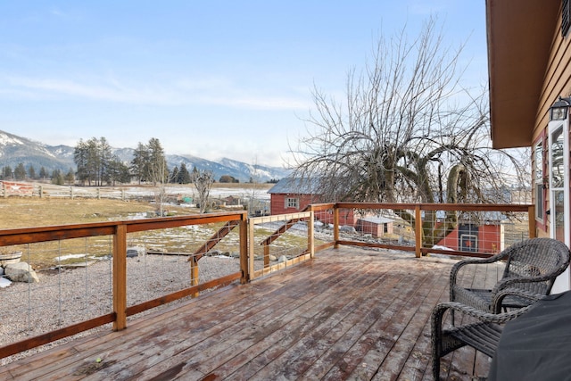 44688 N Foothills Dr, Ronan, MT 59864 - wooden deck featuring a mountain view, an outbuilding, and fence
