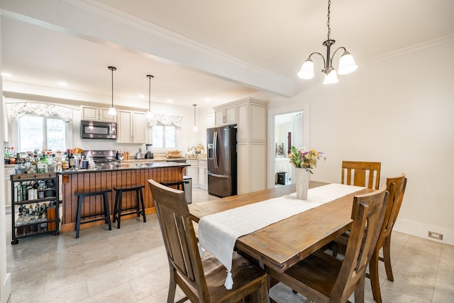 dining area featuring a chandelier, plenty of natural light, light tile patterned floors, and ornamental molding