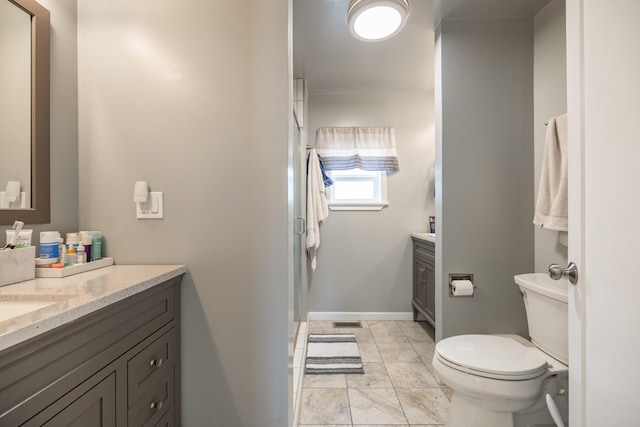 full bath featuring vanity, visible vents, toilet, a stall shower, and baseboards