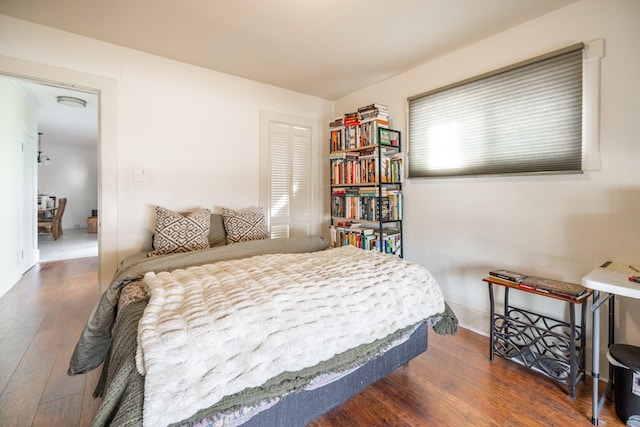 bedroom with baseboards and wood finished floors