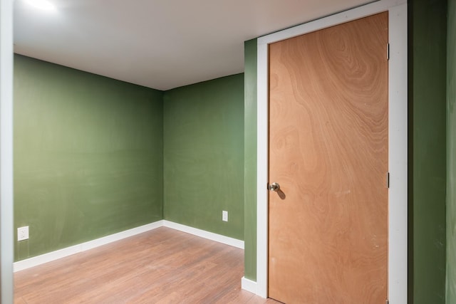 unfurnished room with light wood finished floors and baseboards