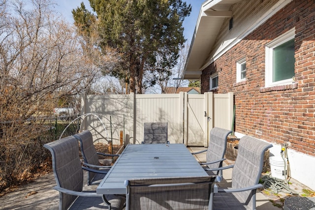 view of patio with outdoor dining area and fence private yard