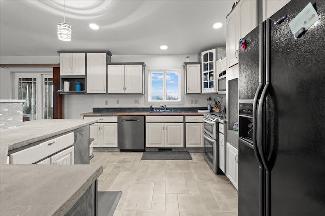 385 Meadow Hills Dr, Kalispell, MT 59901 - kitchen featuring stainless steel appliances, recessed lighting, glass insert cabinets, and hanging light fixtures