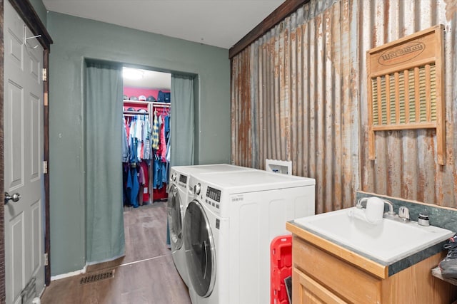 385 Meadow Hills Dr, Kalispell, MT 59901 - washroom with washer and clothes dryer and wood finished floors