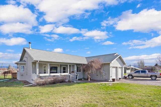 385 Meadow Hills Dr, Kalispell, MT 59901 - single story home with a porch, a front yard, a garage, and gravel driveway