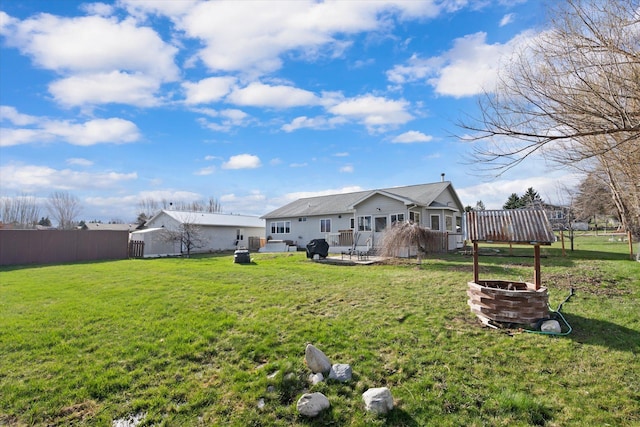 385 Meadow Hills Dr, Kalispell, MT 59901 - rear view of house with an outdoor fire pit, a patio, and a deck