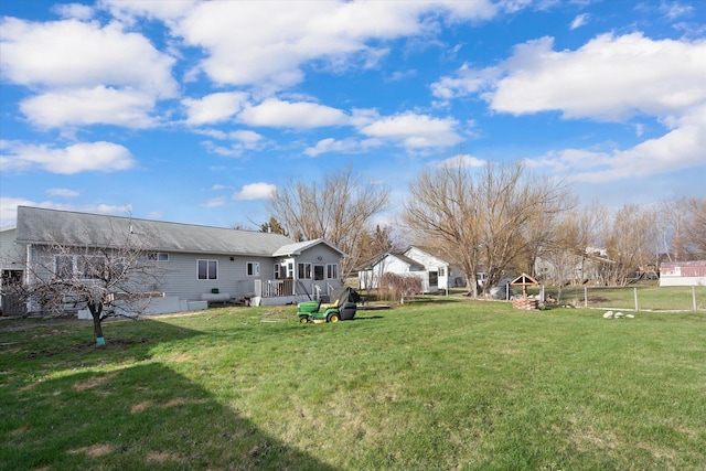 385 Meadow Hills Dr, Kalispell, MT 59901 - view of green lawn featuring a wooden deck
