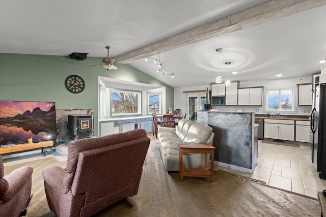 385 Meadow Hills Dr, Kalispell, MT 59901 - living area with a wood stove, ceiling fan, and recessed lighting