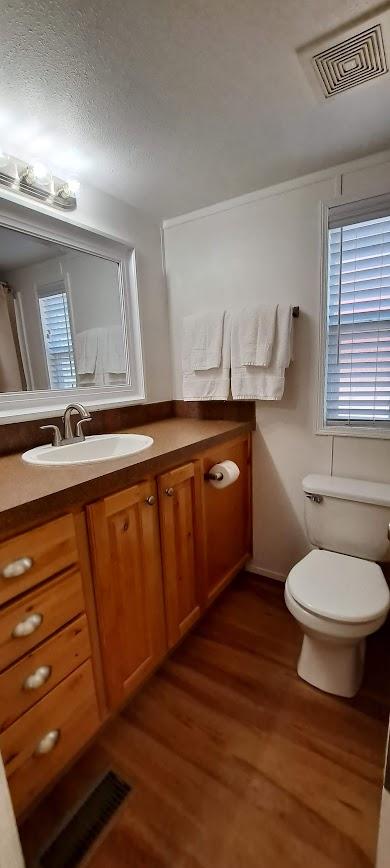 20795 Whispering Pines Rd, Missoula, MT 59808 - bathroom featuring vanity and wood finished floors