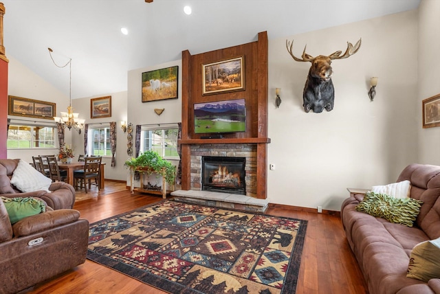 8 Primrose Ct, Kalispell, MT 59901 - living area featuring a chandelier, wood-type flooring, a stone fireplace, recessed lighting, and baseboards