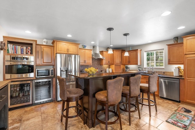 8 Primrose Ct, Kalispell, MT 59901 - kitchen with stainless steel appliances, wall chimney exhaust hood, a sink, dark countertops, and a kitchen bar