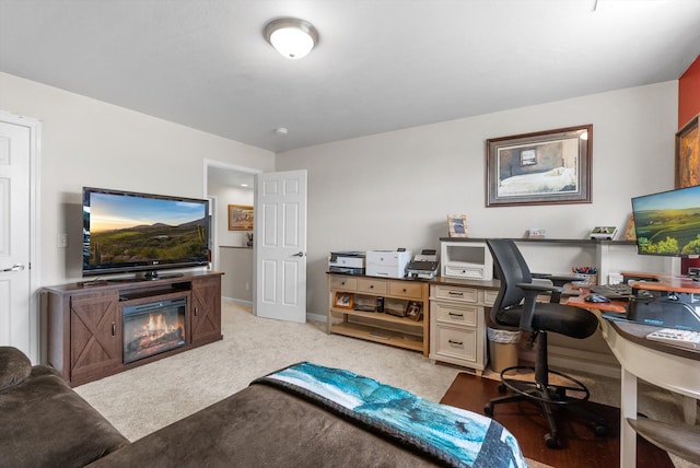 8 Primrose Ct, Kalispell, MT 59901 - office area featuring light colored carpet, baseboards, and a glass covered fireplace