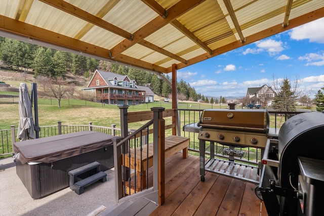8 Primrose Ct, Kalispell, MT 59901 - wooden deck featuring a hot tub, a lawn, and a grill