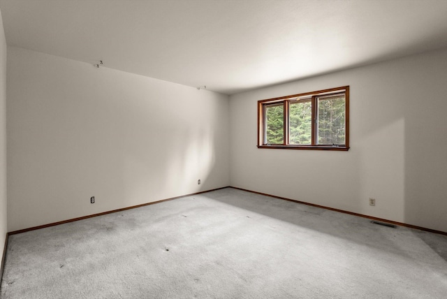 220 Ferndale Dr, Bigfork, MT 59911 - unfurnished room with light carpet and baseboards