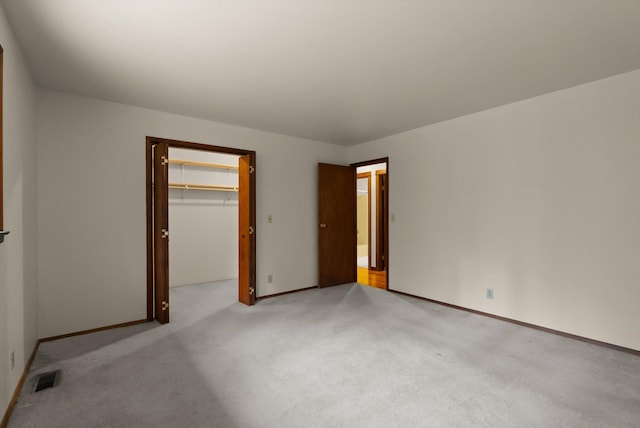 220 Ferndale Dr, Bigfork, MT 59911 - unfurnished bedroom with carpet floors, a walk in closet, and a closet