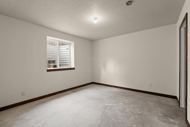 220 Ferndale Dr, Bigfork, MT 59911 - spare room with concrete flooring and baseboards