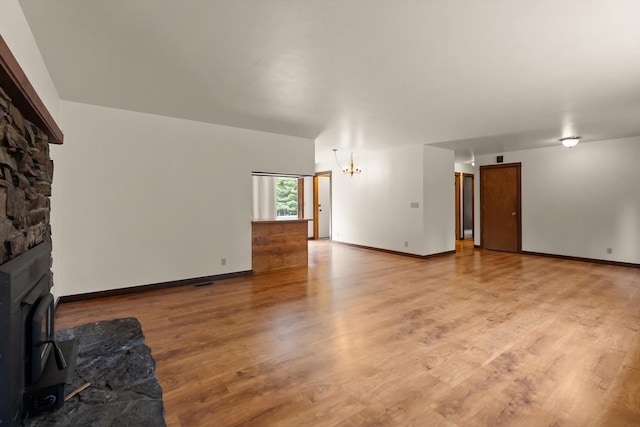 220 Ferndale Dr, Bigfork, MT 59911 - unfurnished living room featuring light wood finished floors and a chandelier