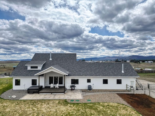 2650 W Valley Dr, Kalispell, MT 59901 - view of front of home featuring covered porch, driveway, a garage, a shingled roof, and a mountain view