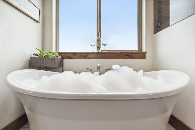 2650 W Valley Dr, Kalispell, MT 59901 - full bathroom with tile patterned floors, connected bathroom, vanity, and a freestanding tub