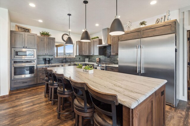 2650 W Valley Dr, Kalispell, MT 59901 - kitchen with a sink, built in appliances, backsplash, light stone counters, and wine cooler