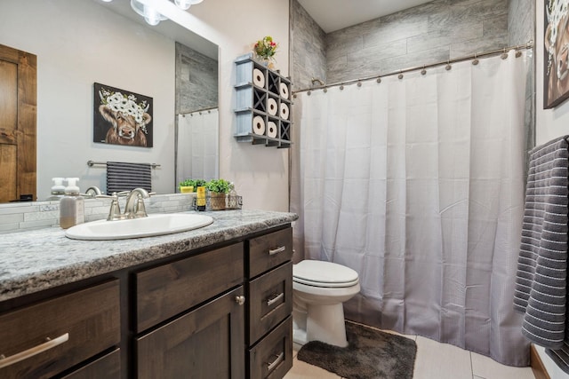 2650 W Valley Dr, Kalispell, MT 59901 - full bathroom with a tile shower, tile patterned flooring, vanity, and toilet
