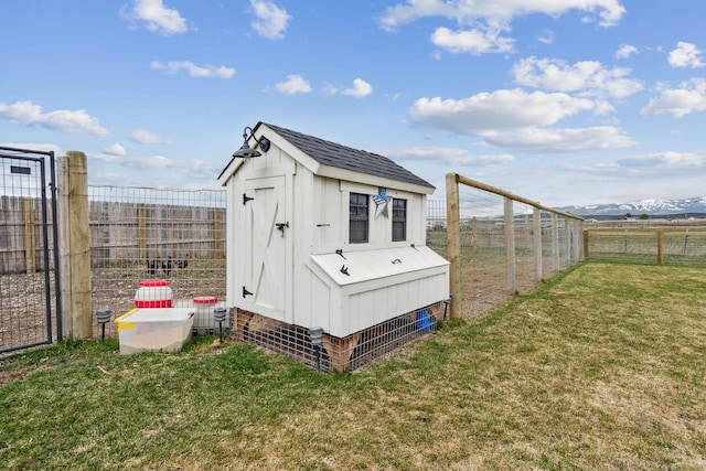 2650 W Valley Dr, Kalispell, MT 59901 - view of yard featuring an outdoor fire pit, a rural view, a mountain view, and fence