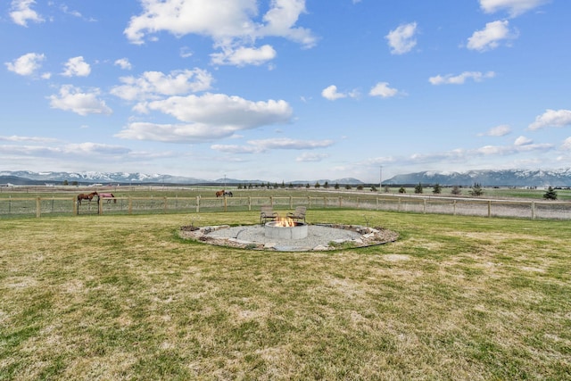 2650 W Valley Dr, Kalispell, MT 59901 - view of yard with an outdoor fire pit, a rural view, and a mountain view