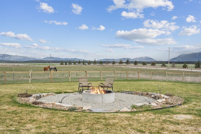 2650 W Valley Dr, Kalispell, MT 59901 - exterior details with a mountain view, a hot tub, and fence