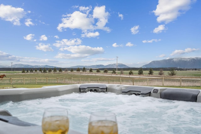 2650 W Valley Dr, Kalispell, MT 59901 - deck with a yard, a rural view, a mountain view, and fence