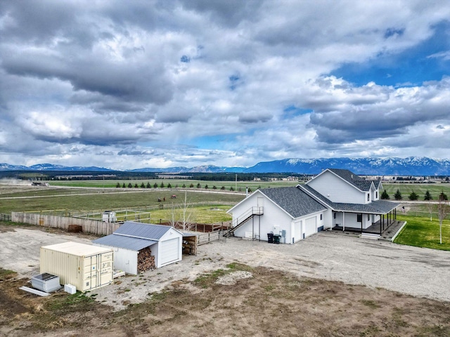 2650 W Valley Dr, Kalispell, MT 59901 - rear view of property with a yard, a mountain view, fence, a patio area, and a fire pit