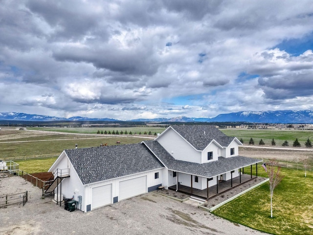 2650 W Valley Dr, Kalispell, MT 59901 - rear view of house with roof with shingles, central AC, a patio, a jacuzzi, and a deck with mountain view