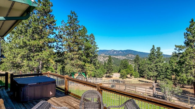 5 Alpine Valley Ln, Clancy, MT 59634 - wooden terrace with a hot tub, a playground, a fenced backyard, and a mountain view
