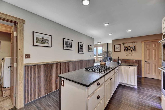 5 Alpine Valley Ln, Clancy, MT 59634 - kitchen with stainless steel gas cooktop, washer / dryer, wainscoting, dark countertops, and dark wood finished floors