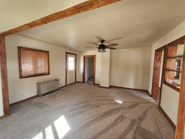 105 Stapp Ln, Darby, MT 59829 - empty room featuring carpet flooring, baseboards, a ceiling fan, and heating unit