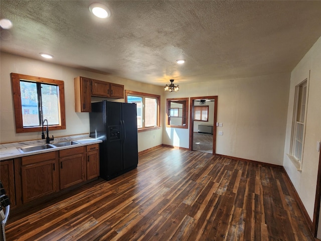 105 Stapp Ln, Darby, MT 59829 - kitchen with black refrigerator with ice dispenser, a sink, light countertops, dark wood-style floors, and a textured ceiling