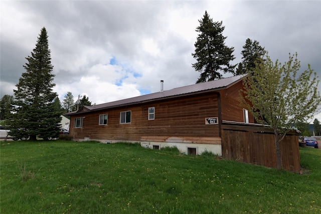 261 Locust Ln, Seeley Lake, MT 59868 - view of home's exterior featuring a lawn and a metal roof