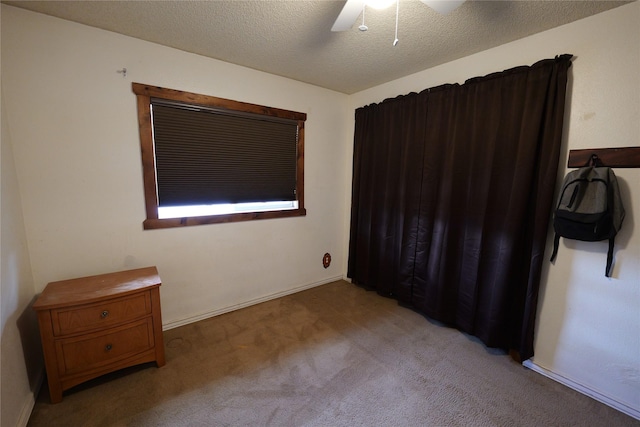 261 Locust Ln, Seeley Lake, MT 59868 - bedroom featuring light colored carpet, ceiling fan, and a textured ceiling