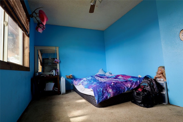 261 Locust Ln, Seeley Lake, MT 59868 - carpeted bedroom featuring a textured ceiling and a ceiling fan